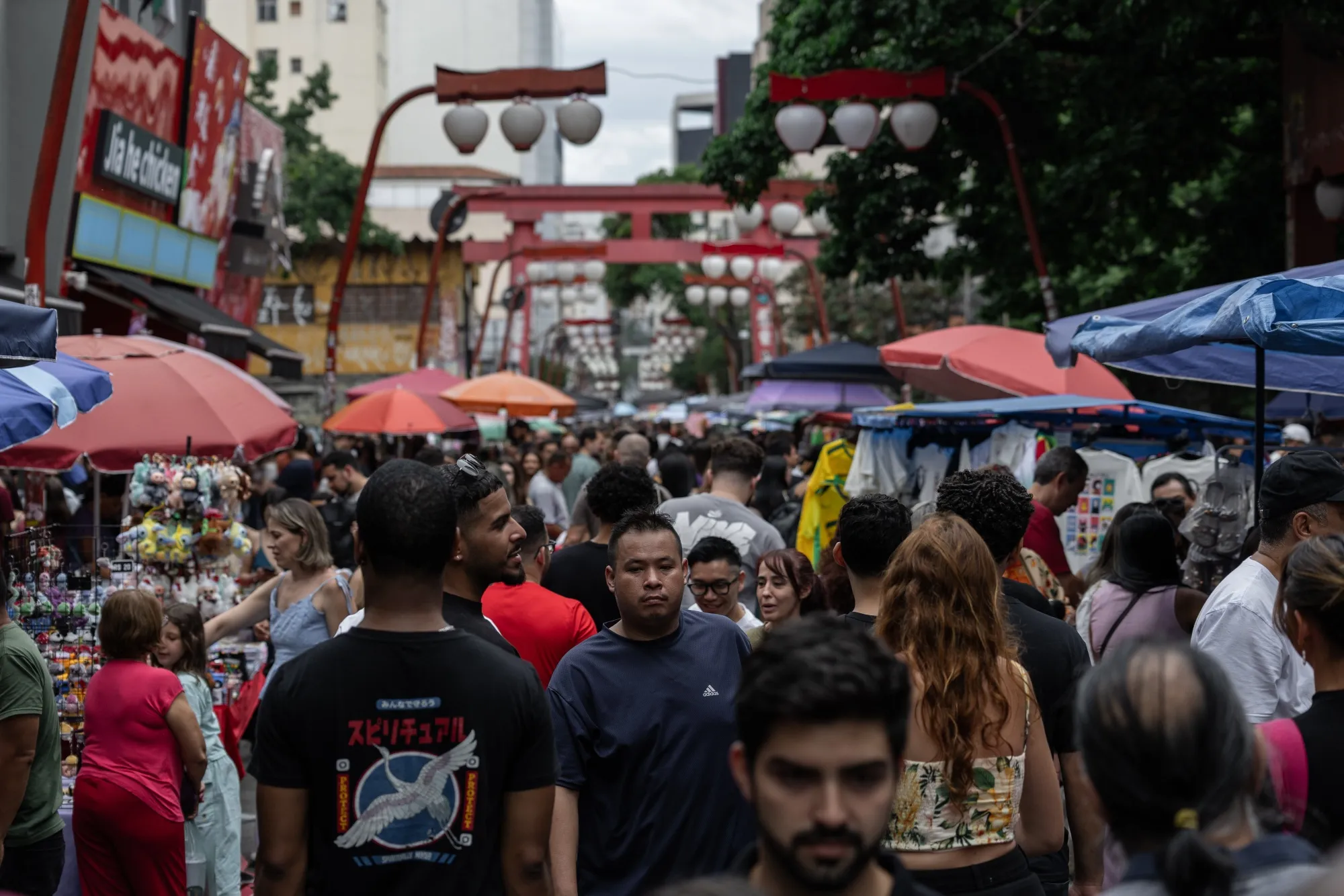 Shoppers and tourists at a street market in the Liberdade neighborhood of Sao Paulo.