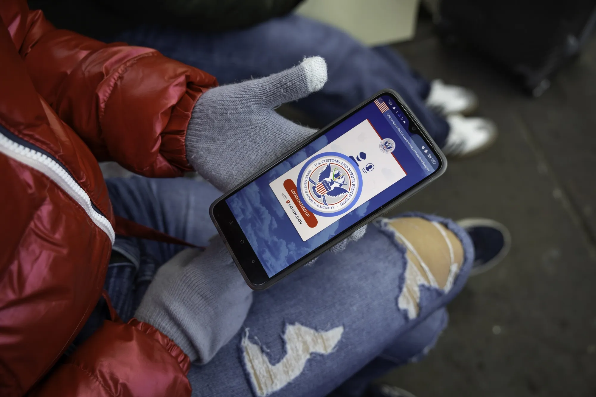 An immigrant from Venezuela tries to access the CBP One app&nbsp;in Nogales, Mexico, on Jan. 21.