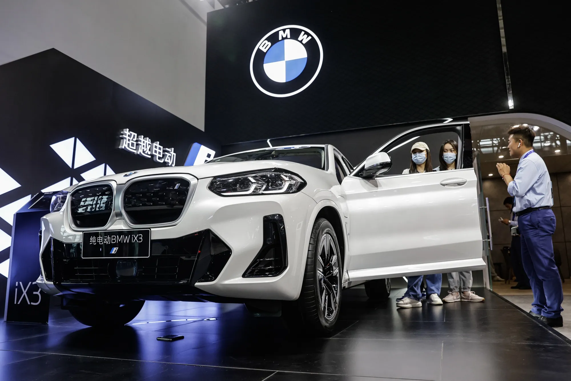 Attendees look at a BMW Ix3 during the 2023 Central China International Auto Show in Wuhan.