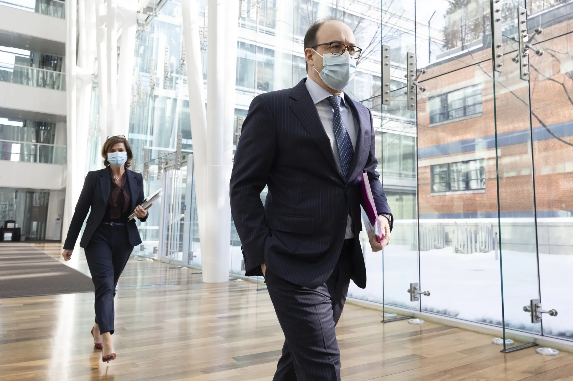 Charles Emond, chief executive officer of Caisse de Depot et Placement du Quebec, right, arrives for a news conference in Montreal in February.