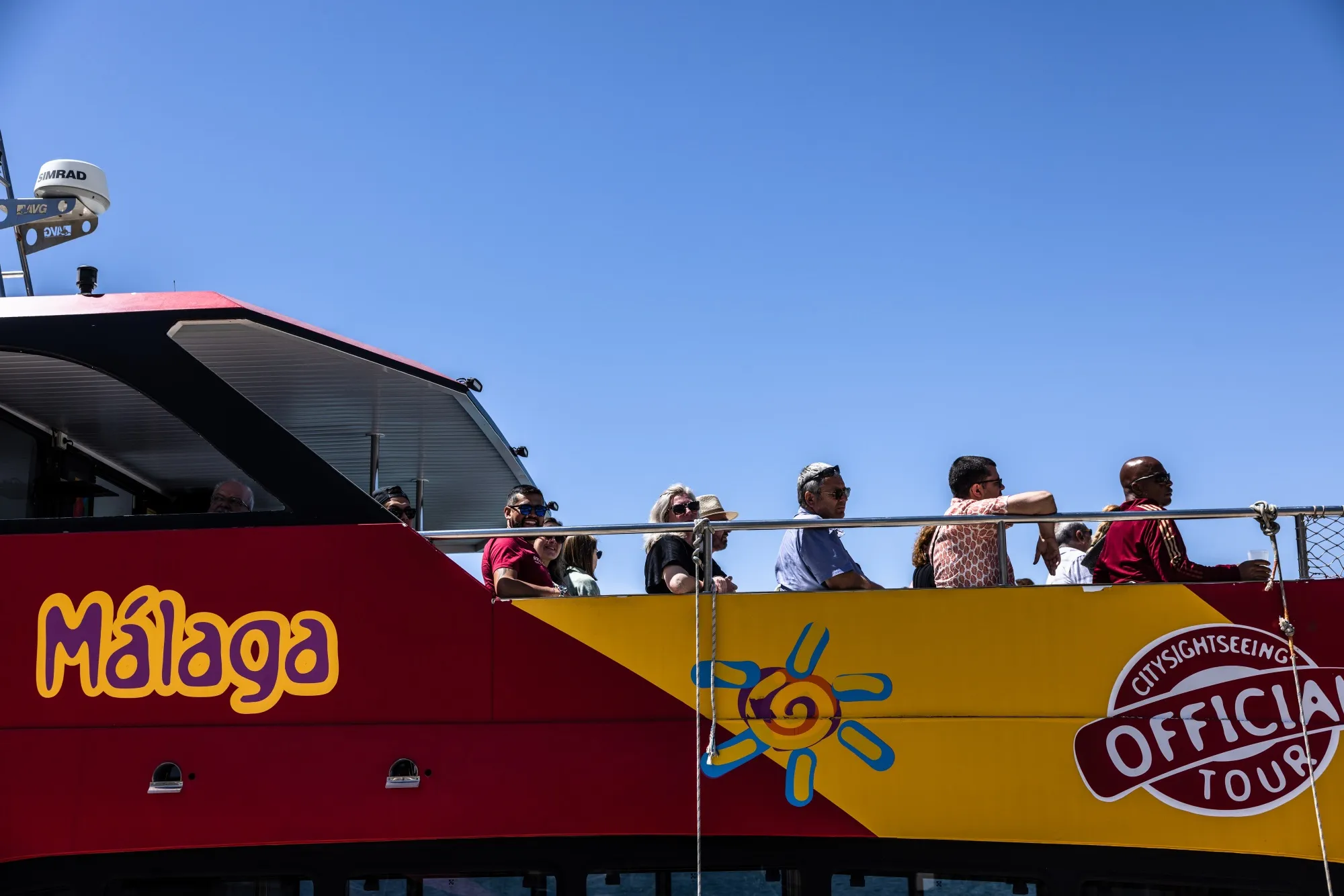 Tourists ride a sightseeing catamaran in Malaga, Spain.