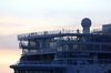 Passengers stand on the decks of the Costa Smeralda cruise ship, operated by Carnival Corp., docked at the port of Civitavecchia near Rome, Italy, on Thursday, Jan. 30, 2020. The cruise ship was blocked from leaving an Italian port with some 7,000 people on board, after a passenger came down with symptoms that raised concerns about a possible case of coronavirus.