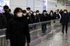 Commuters on a moving walkway at a subway station in Seoul on Dec. 14.