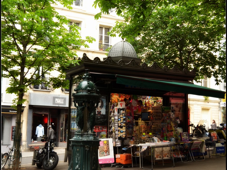 A classic Parisian kiosk, with an equally iconic Wallace Fountain in the foreground.