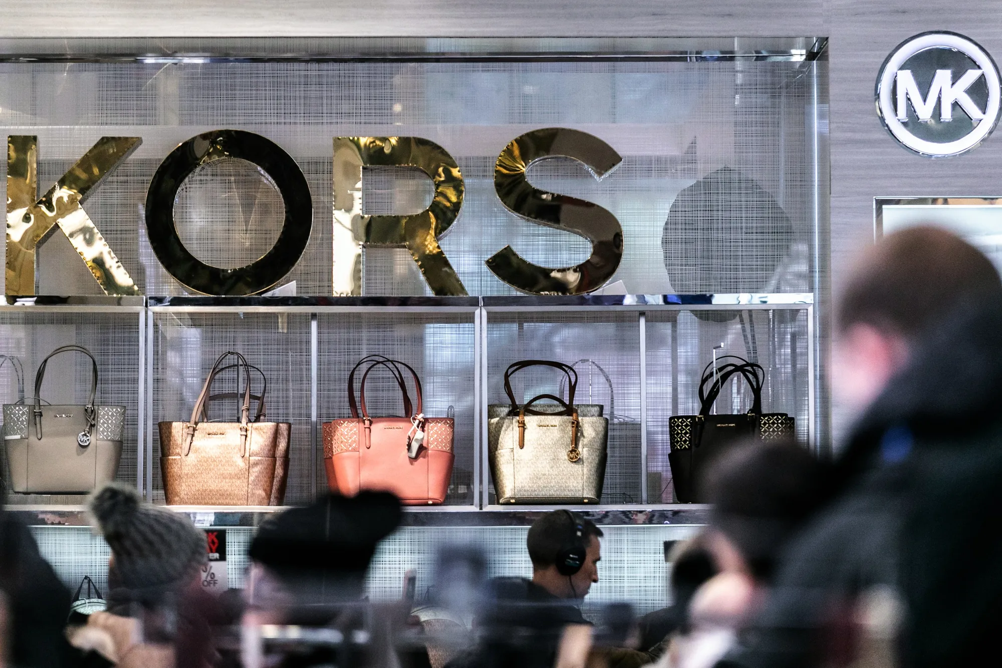 Michael Kors Holdings Ltd. handbags sit on display at the Macy's Inc. flagship store in New York.