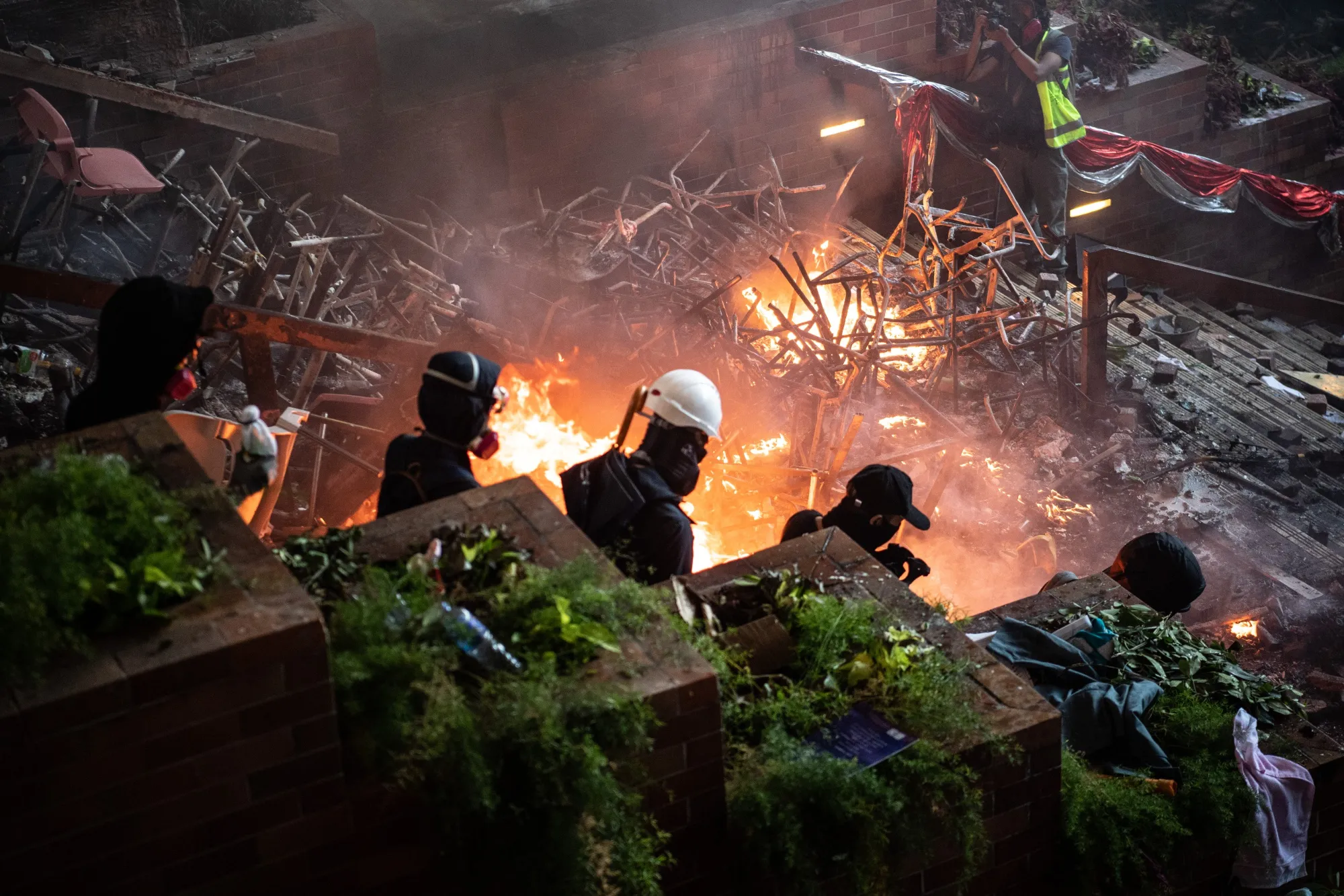 Protesters walk past a fire during clashes with police at Hong Kong Polytechnic University on Nov. 18.