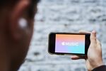 Apple Music streaming service signage is displayed on an iPhone in an arranged photograph taken in the Queens Borough of New York, U.S.