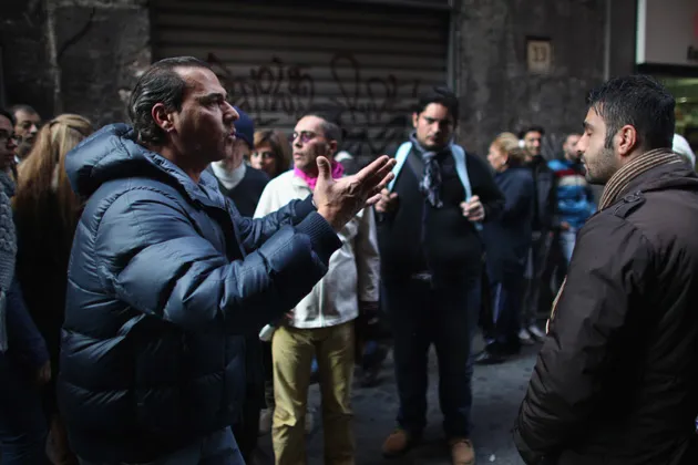 An Italian street vendor (left) talks about his plight during a clampdown by authorities against illegal street trading in central Naples