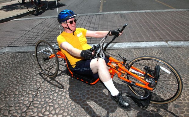 Adaptive cycles make riding easier for those with disabilities. Here, a man tests a hand-powered trike designed for veterans with prosthetic limbs.