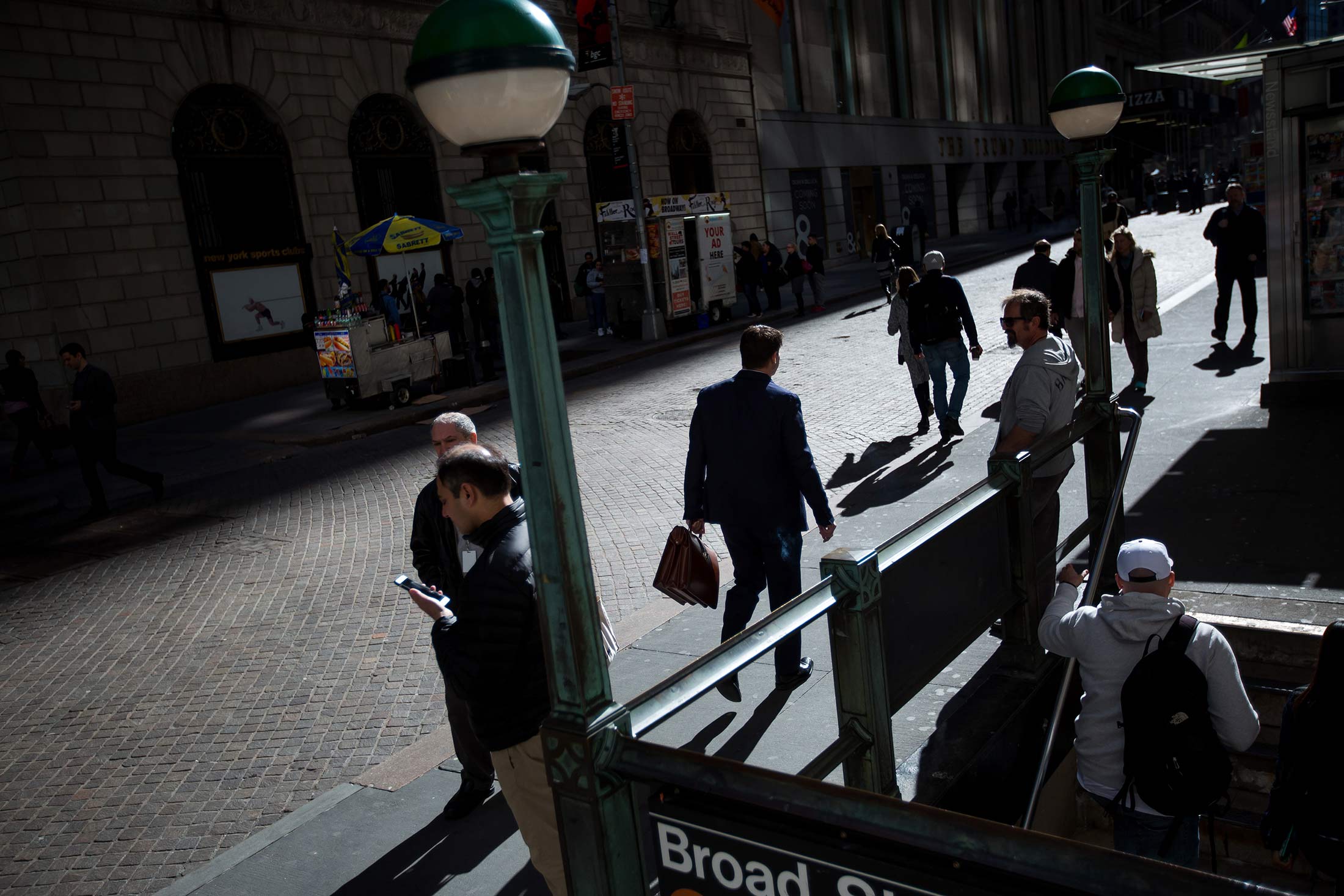 Pedestrians walk along Wall Street near the New York Stock Exchange (NYSE)
