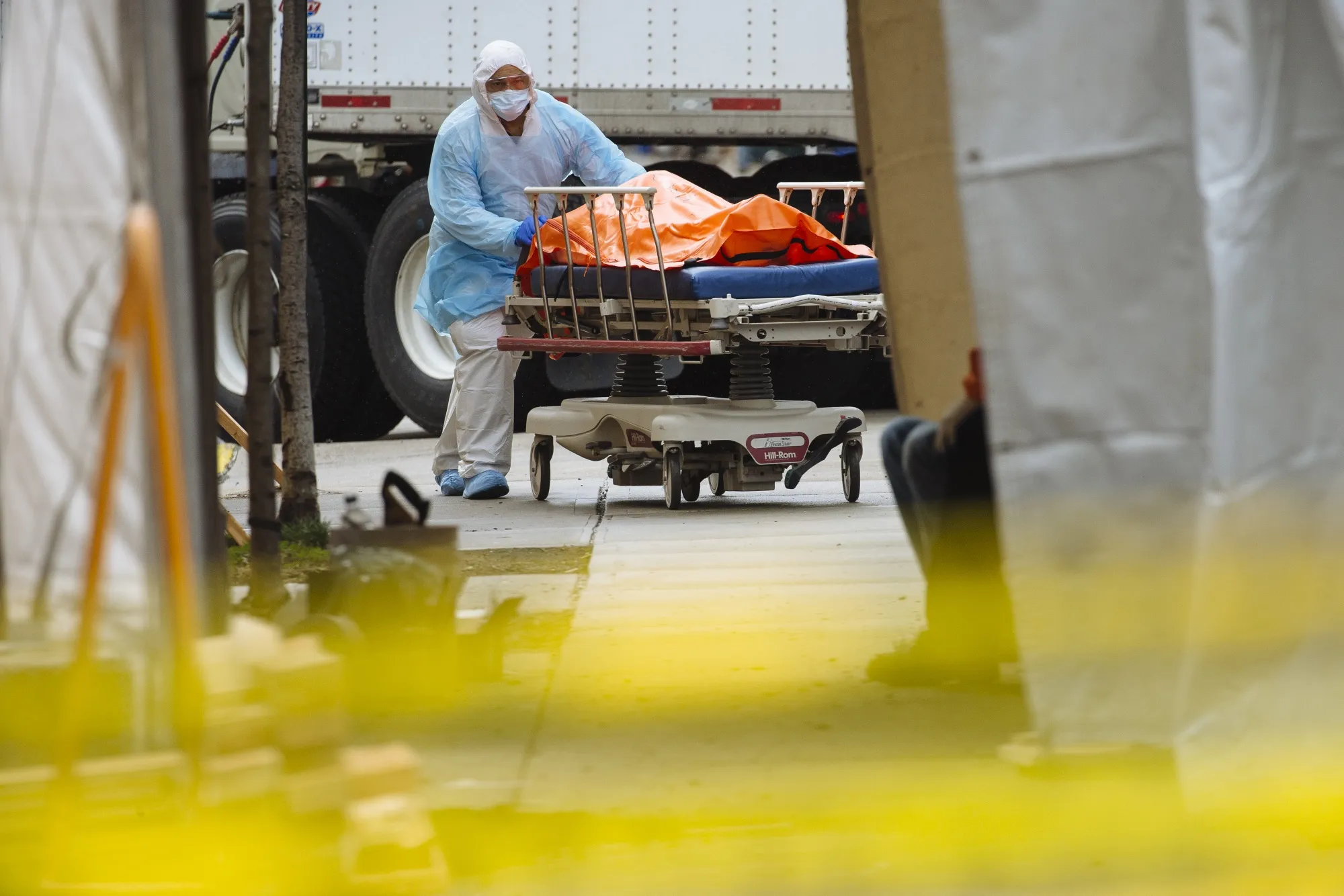A medical worker moves the body of a deceased patient to an overflow morgue outside the Wyckoff Heights Medical Center in Brooklyn, New York, on April 3.&nbsp;