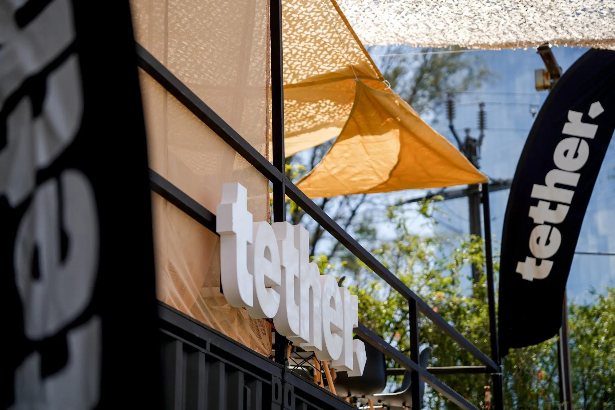 Signage at the Tether Holdings booth on the exhibition floor in San Salvador, El Salvador.