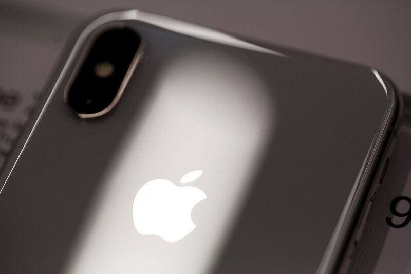 A logo sits on the case of an iPhone X smartphone 