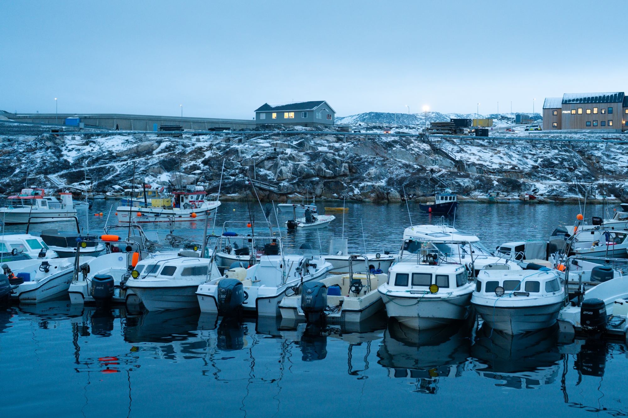 Fishing boats in the harbor at Ilulissat, Greenland, on Monday, Jan. 12, 2026. Greenland's government said it will intensify efforts to ensure the island's defenses are managed within the NATO military alliance, pushing back on renewed threats from the US about taking over the territory. Photographer: Juliette Pavy/Bloomberg