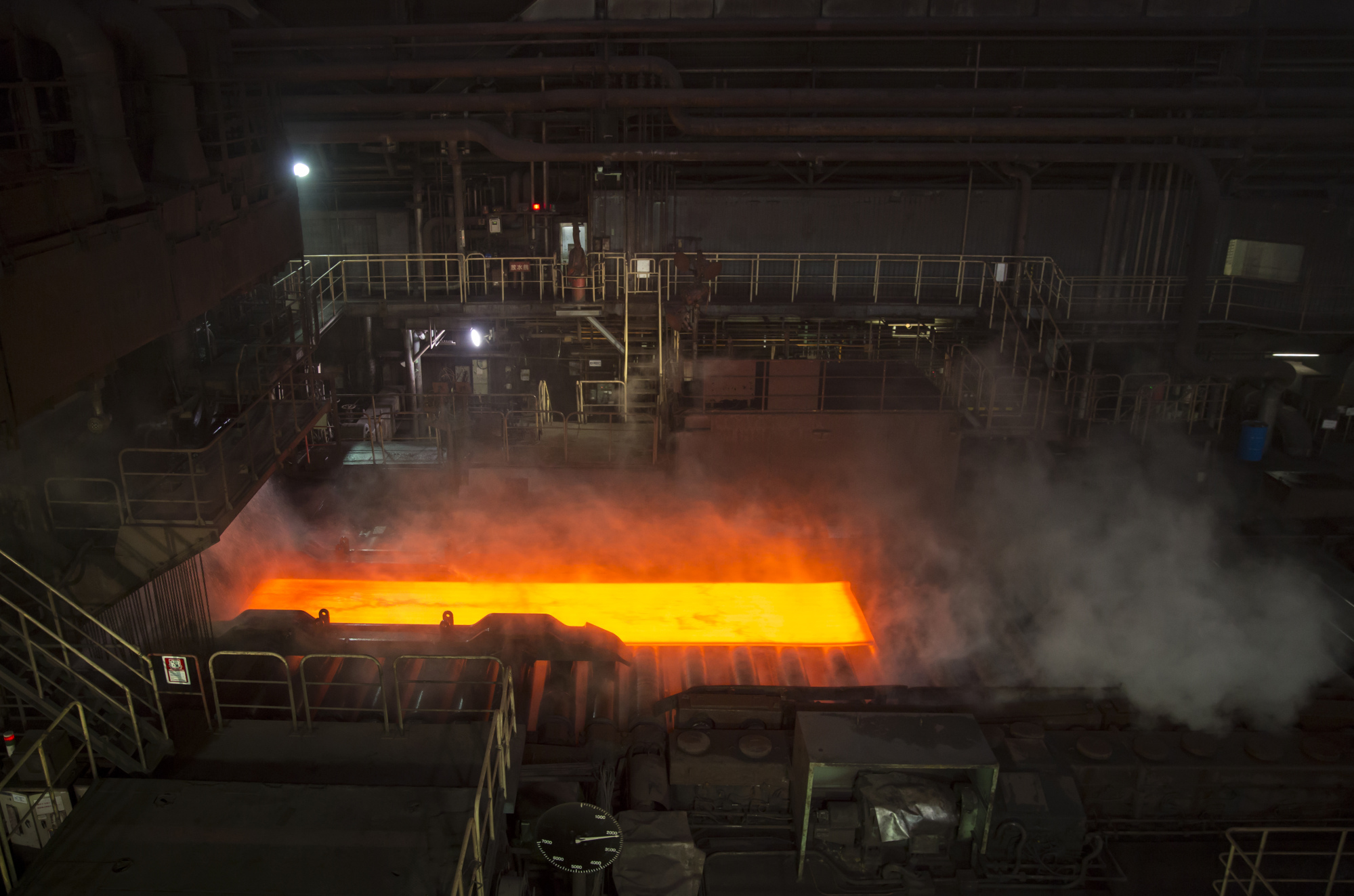 A hot steel slab moves along a conveyor of a plate mill at the Nippon Steel plant in Kashima, Ibaraki, Japan.