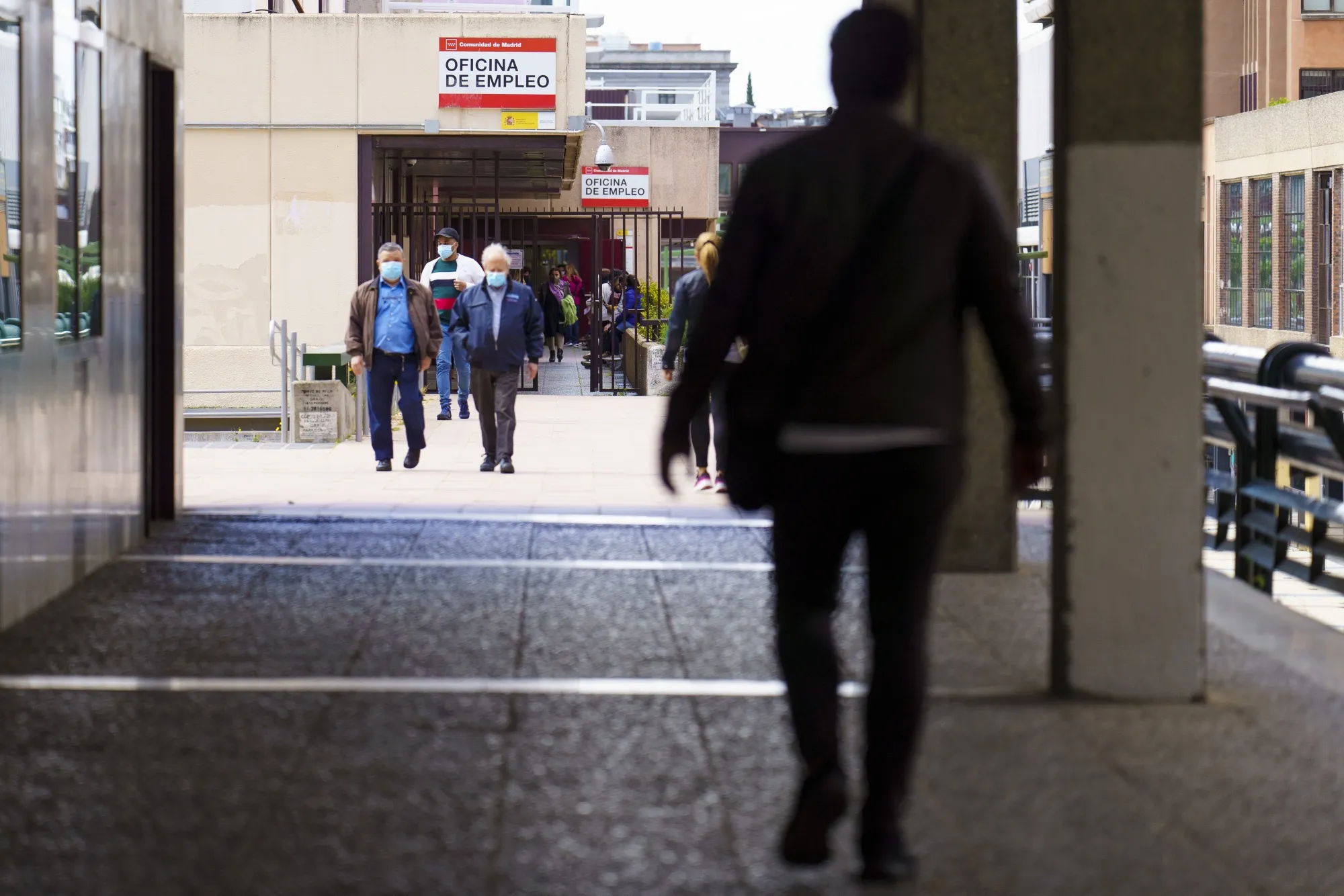 People depart an employment agency office in Madrid, Spain.