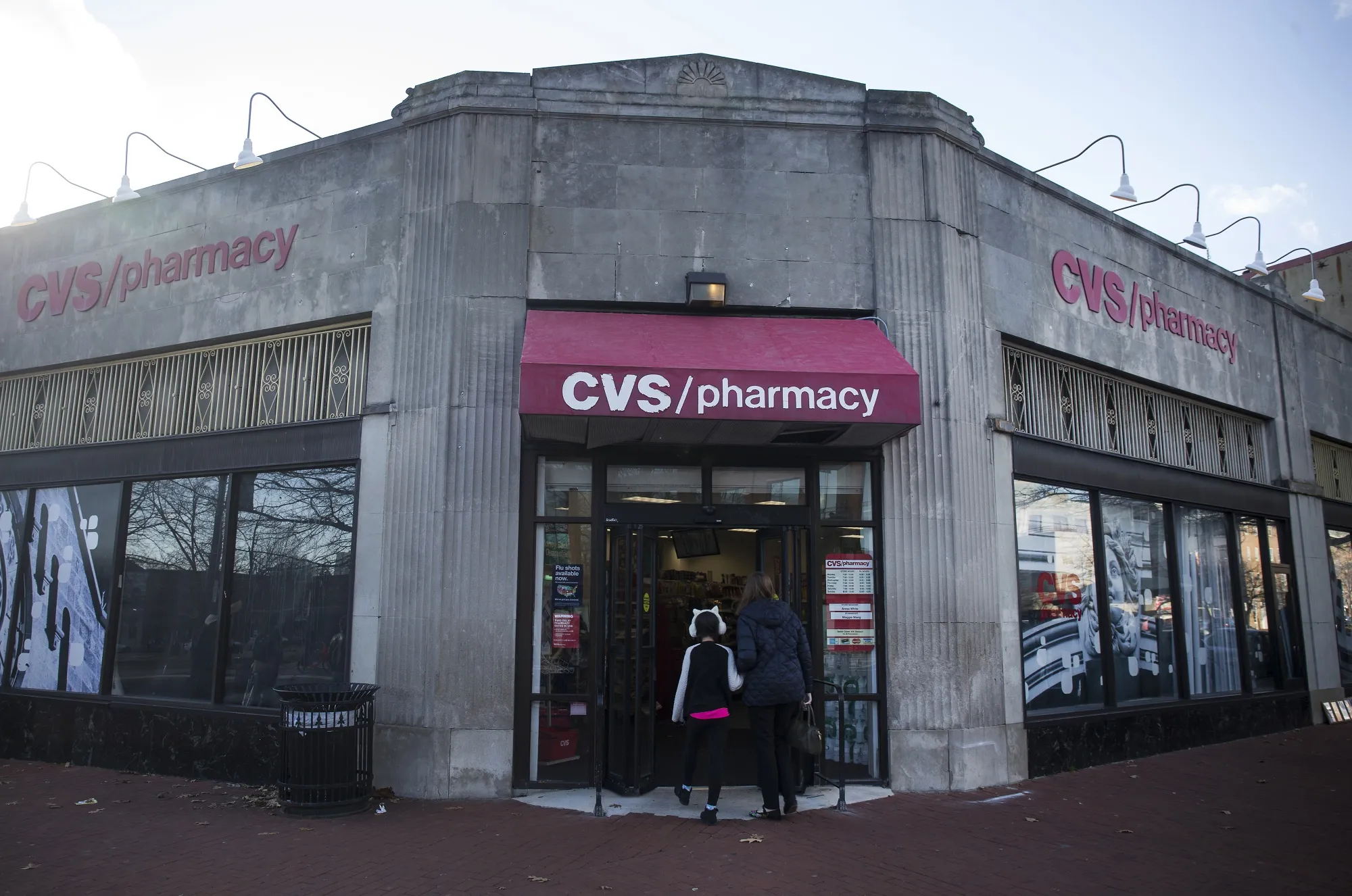 People walk into a CVS Health Corp. store in Washington, DC.