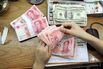 A Chinese bank worker counts 100-yuan no