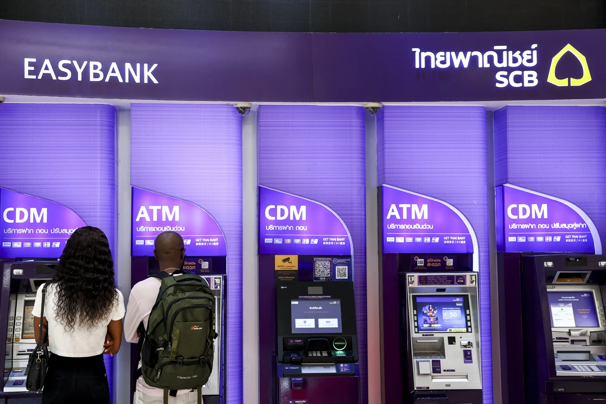 Cash machines at a Siam Commercial Bank Pcl bank branch in Bangkok.