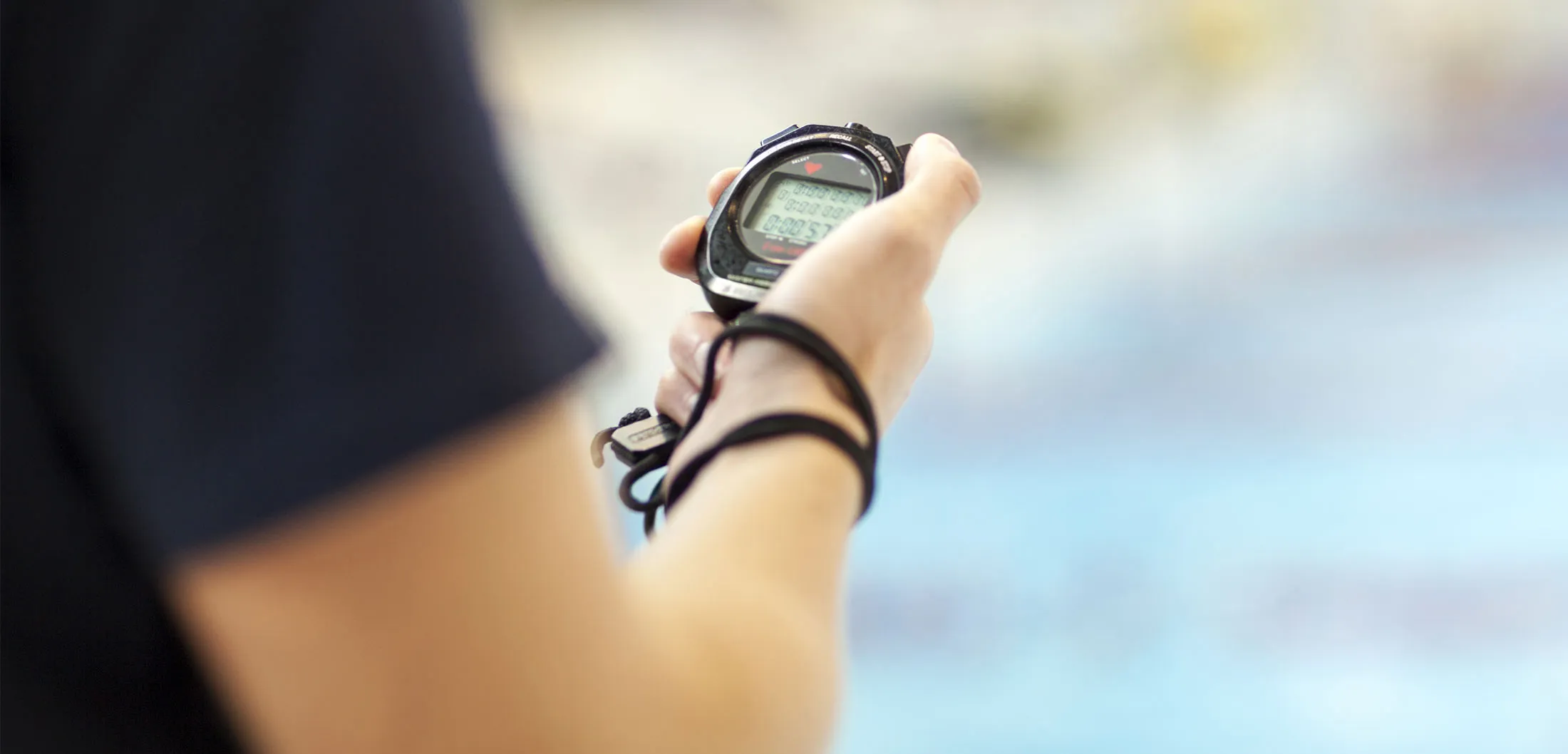Swimming Coach Holding Stopwatch