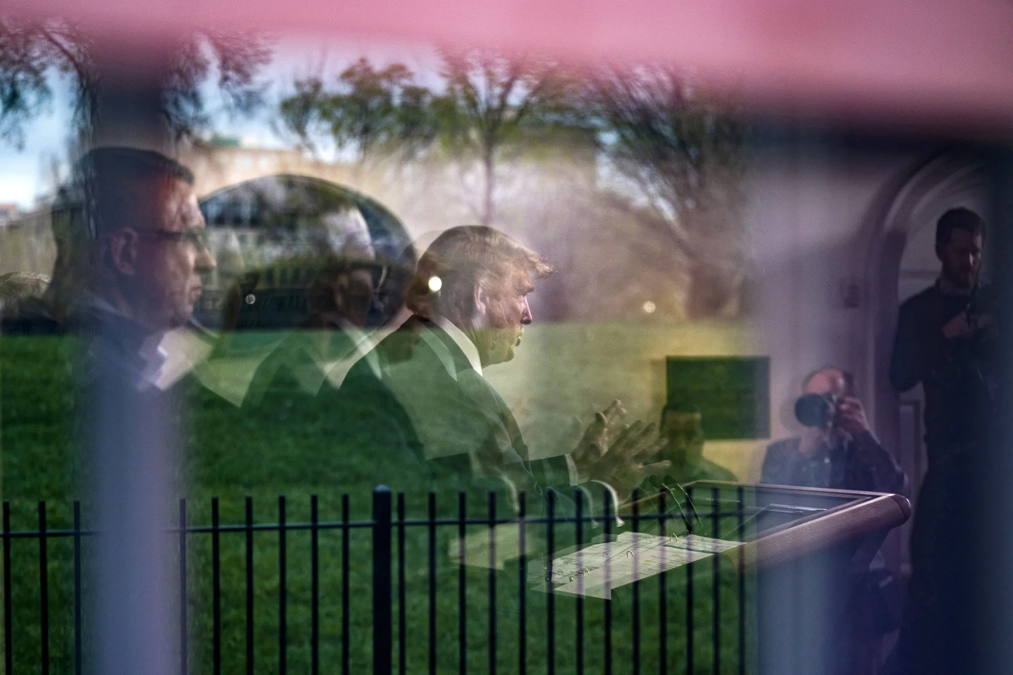 U.S. President Donald Trump is seen through a window as he speaks during a Coronavirus Task Force news conference in the briefing room of the White House on March 22, 2020.&nbsp;