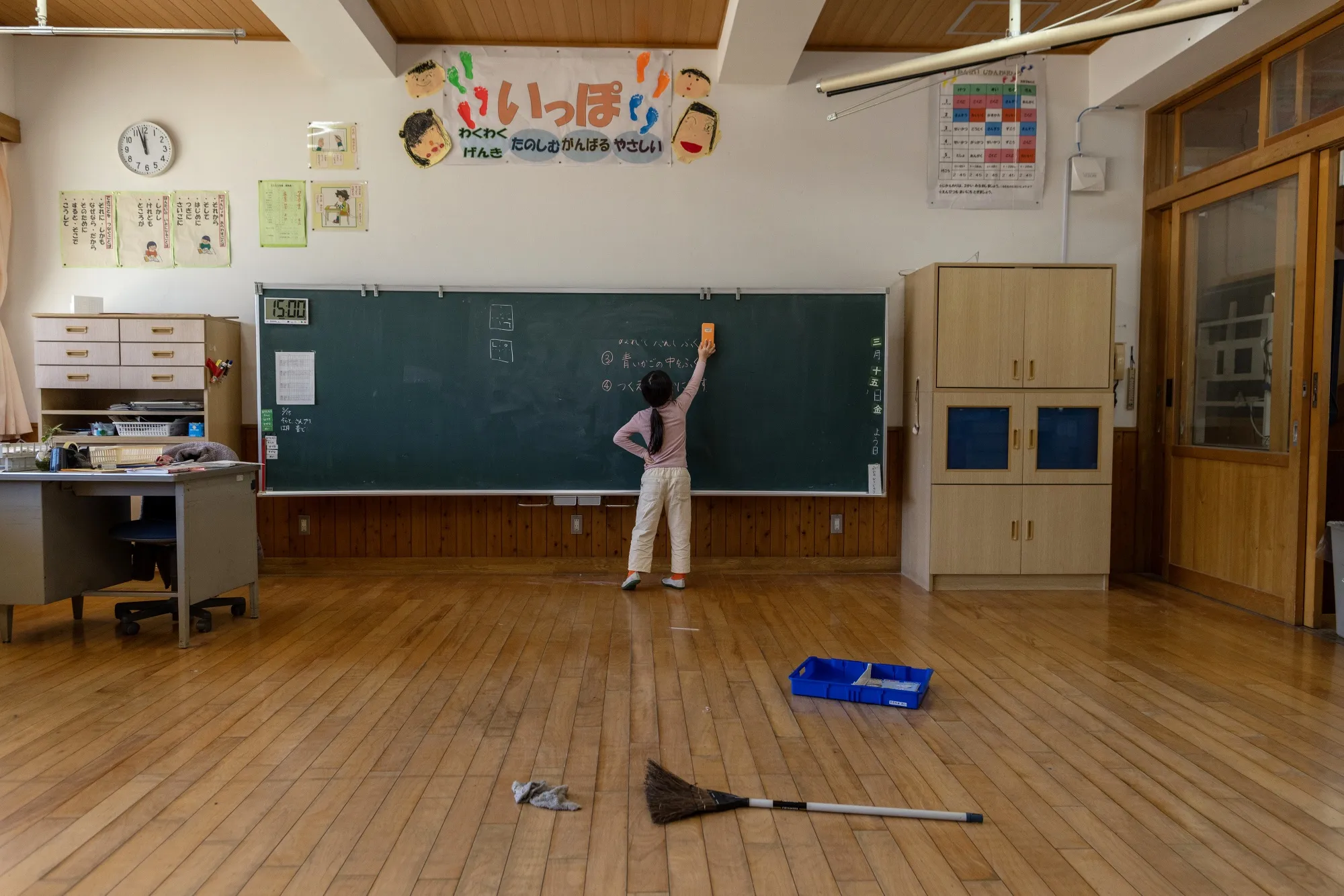 A second-grade student cleans a classroom in Tamba, Hyogo Prefecture, Japan.