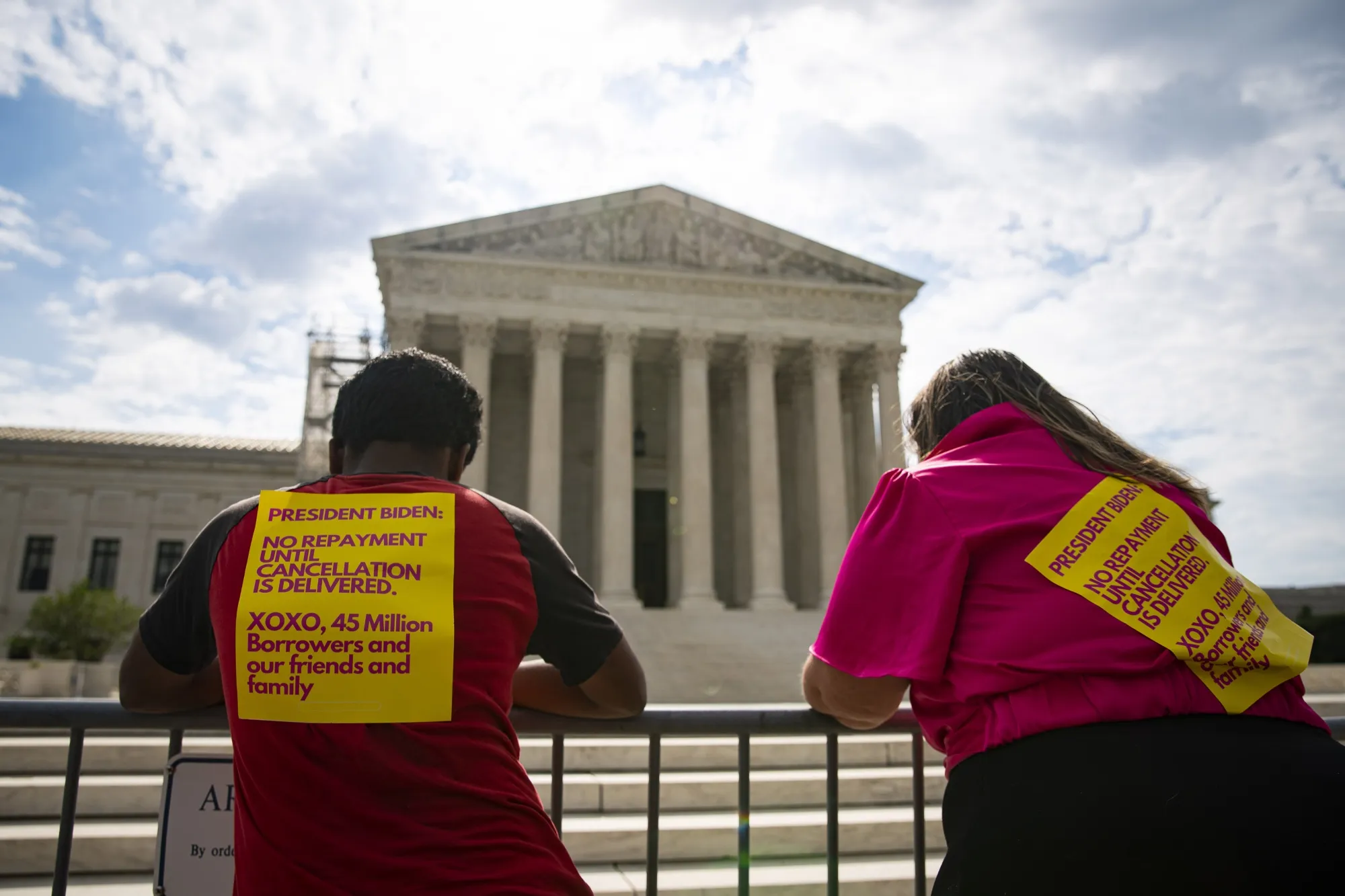 Visitors with signs regarding student loan payments outside of the US Supreme Court in Washington, in June.&nbsp;