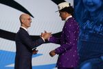 Paolo Banchero, right, is congratulated by NBA Commissioner Adam Silver after being selected as the number one pick overall by the Orlando Magic in the NBA basketball draft, Thursday, June 23, 2022, in New York. (AP Photo/John Minchillo)