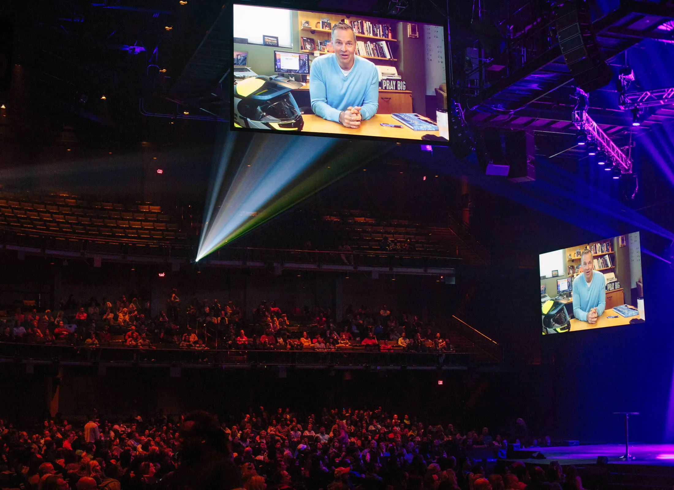 Brian Tome, senior pastor at Crossroads, appears in a recorded message during a service in Cincinnati.