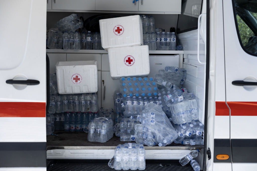 Supplies of bottled water for tourists in an Hellenic Red Cross medical support van at the entrance to the Acropolis during extreme hot weather in Athens.