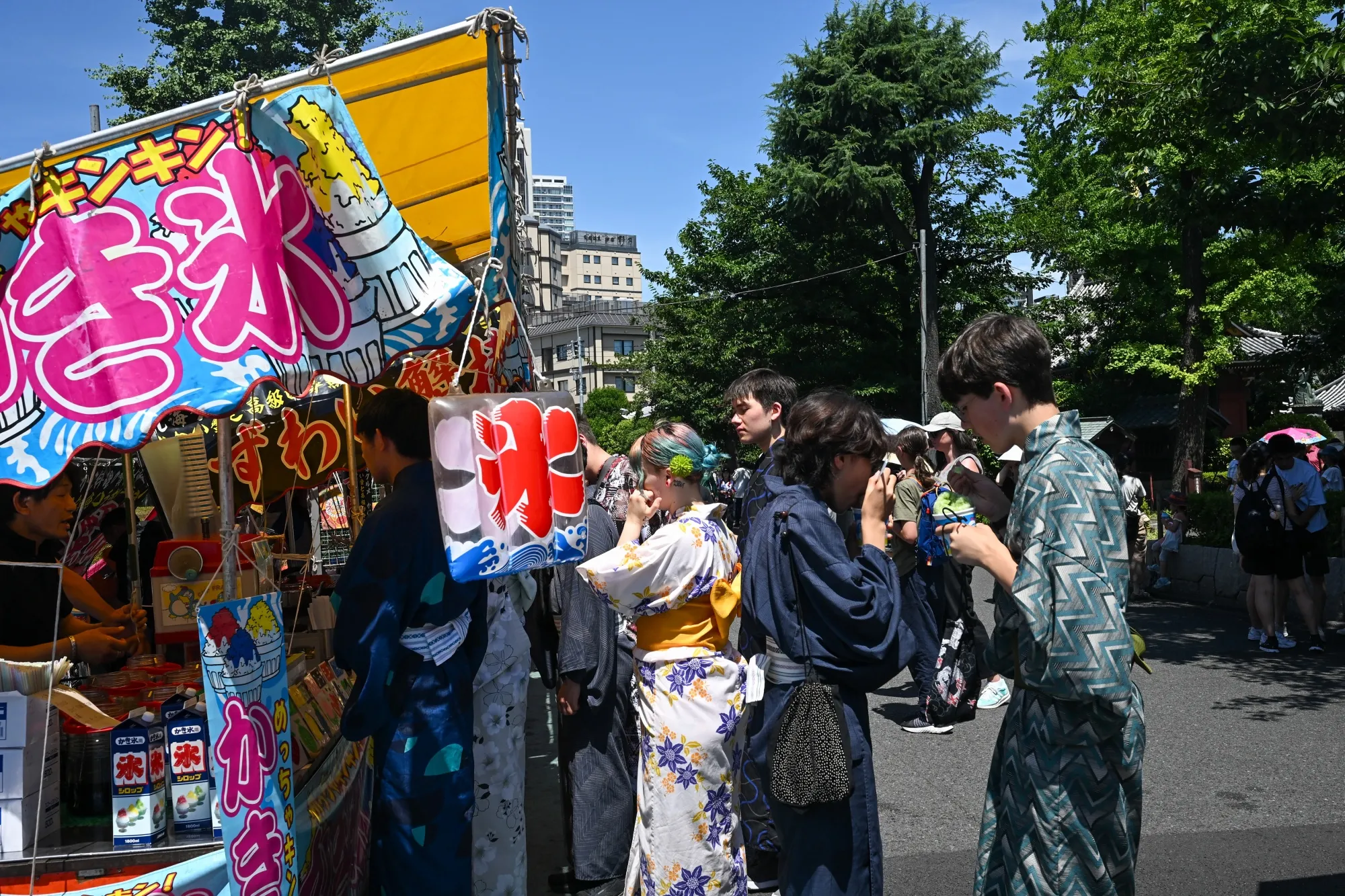 Kimono-clad tourists buy shaved ice at a stall in the Asakusa district of Tokyo.