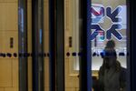 An employee leaves the Royal Bank of Scotland Group Plc offices in London, U.K., on Wednesday, Feb. 15, 2017.