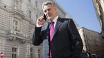 Dmitry Firtash, the Ukrainian billionaire, speaks on his mobile telephone outside the Group DF offices following a Bloomberg Television interview in Vienna on March 14, 2016.
