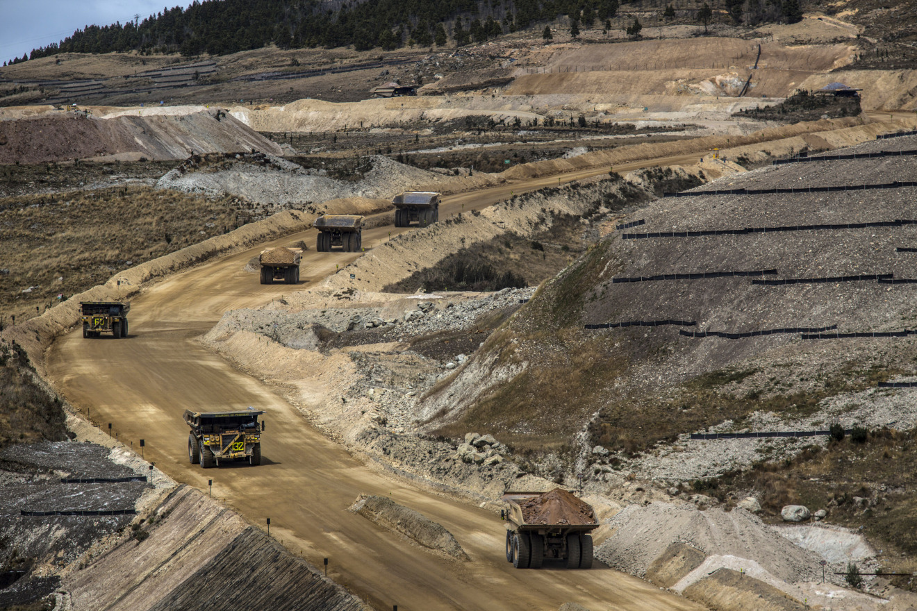 Dump trucks haul soil away from a pit at the Yanacocha gold mine in Cajamarca, Peru, on Thursday, Oct. 15, 2015.&nbsp;
