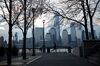 A jogger passes in front of buildings on the Lower Manhattan skyline along the waterfront in Jersey City, New Jersey, U.S., on Tuesday, April 21, 2020.