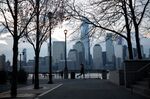 A jogger passes in front of buildings on the Lower Manhattan skyline along the waterfront in Jersey City, New Jersey, U.S., on Tuesday, April 21, 2020.