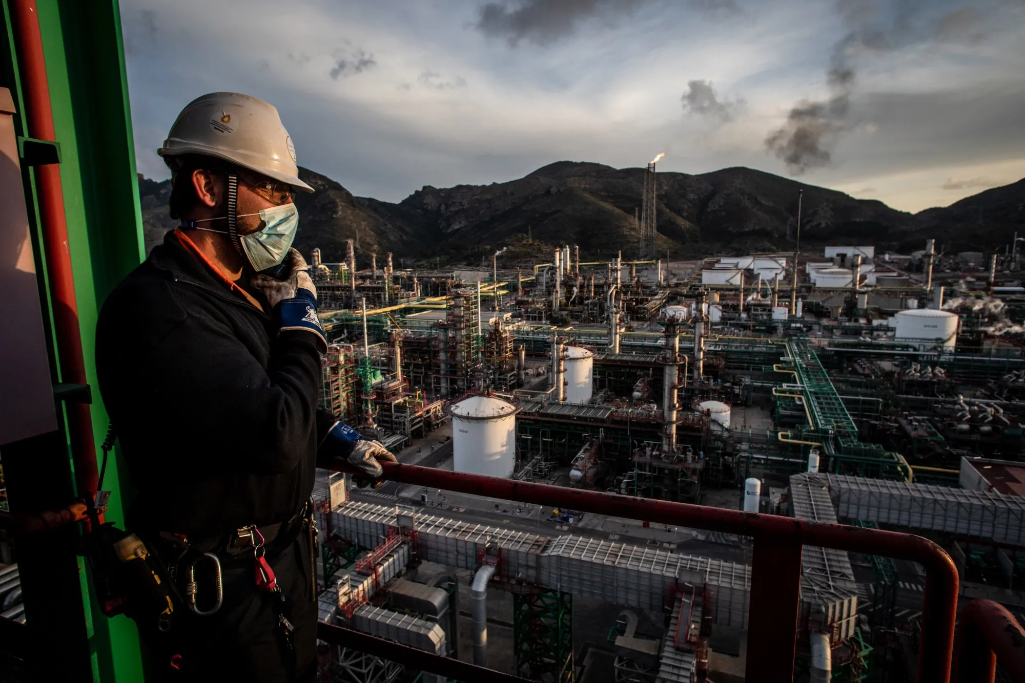 An employee looks out&nbsp;over Repsol SA's Cartagena oil refining complex in Cartagena, Spain.