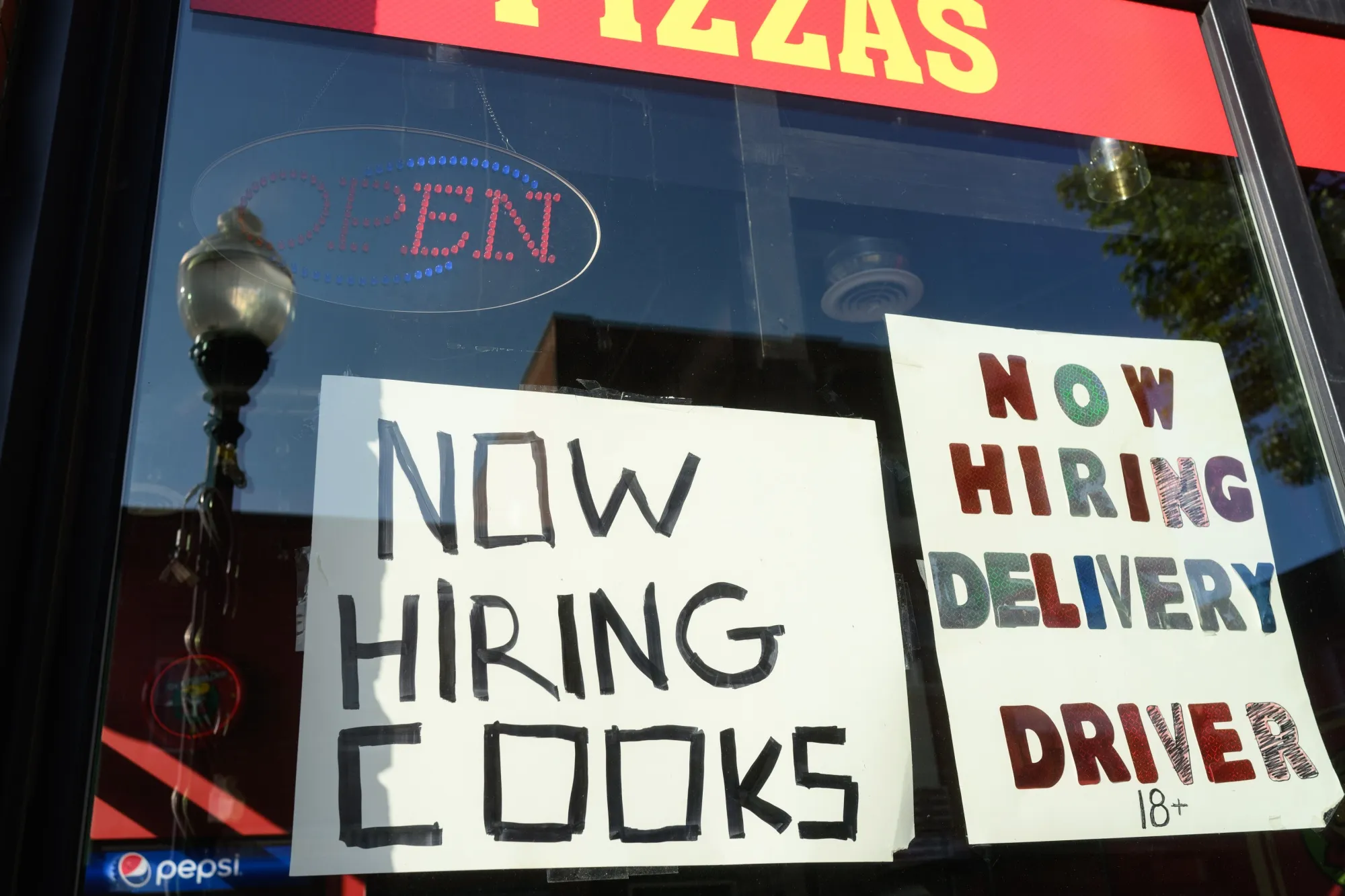 A “Help Wanted” sign outside a pizzeria in Mount Pleasant, Pennsylvania.
