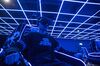 An employee wears a virtual reality (VR) headset while demonstrating a 4D cinema that can accommodate 23 people at the SoReal virtual reality park in Beijing, China.
