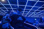 An employee wears a virtual reality (VR) headset while demonstrating a 4D cinema that can accommodate 23 people at the SoReal virtual reality park in Beijing, China.