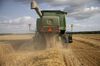 A worker operates a Deere & Co. John Deere brand combine harvester during a wheat harvest at a farm in Kirkland, Illinois, U.S., on Monday, July 15, 2019. A heat wave through most of the U.S. is expected to be supportive for grains futures at a time when an already-compromised crop due to an overly-wet planting season is in a fragile state.