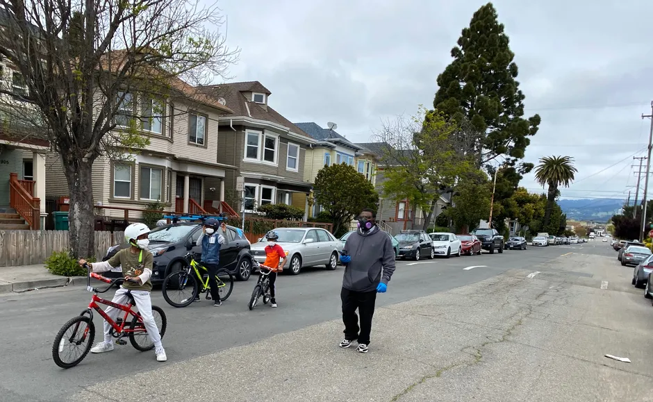 A family walks down West 19th Street in Oakland, part of the city's "slow streets" network.