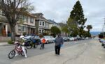 A family walks down West 19th Street in Oakland, part of the city's &quot;slow streets&quot; network.