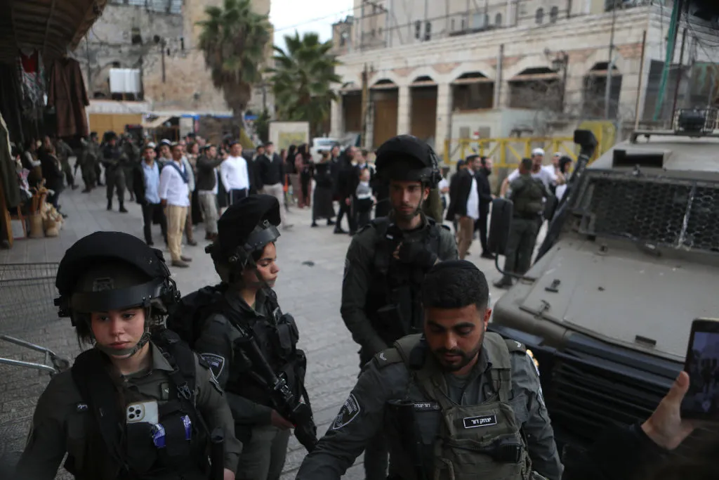 Israeli settlers escorted by Israeli forces in Hebron city, West Bank, on Jan. 4.