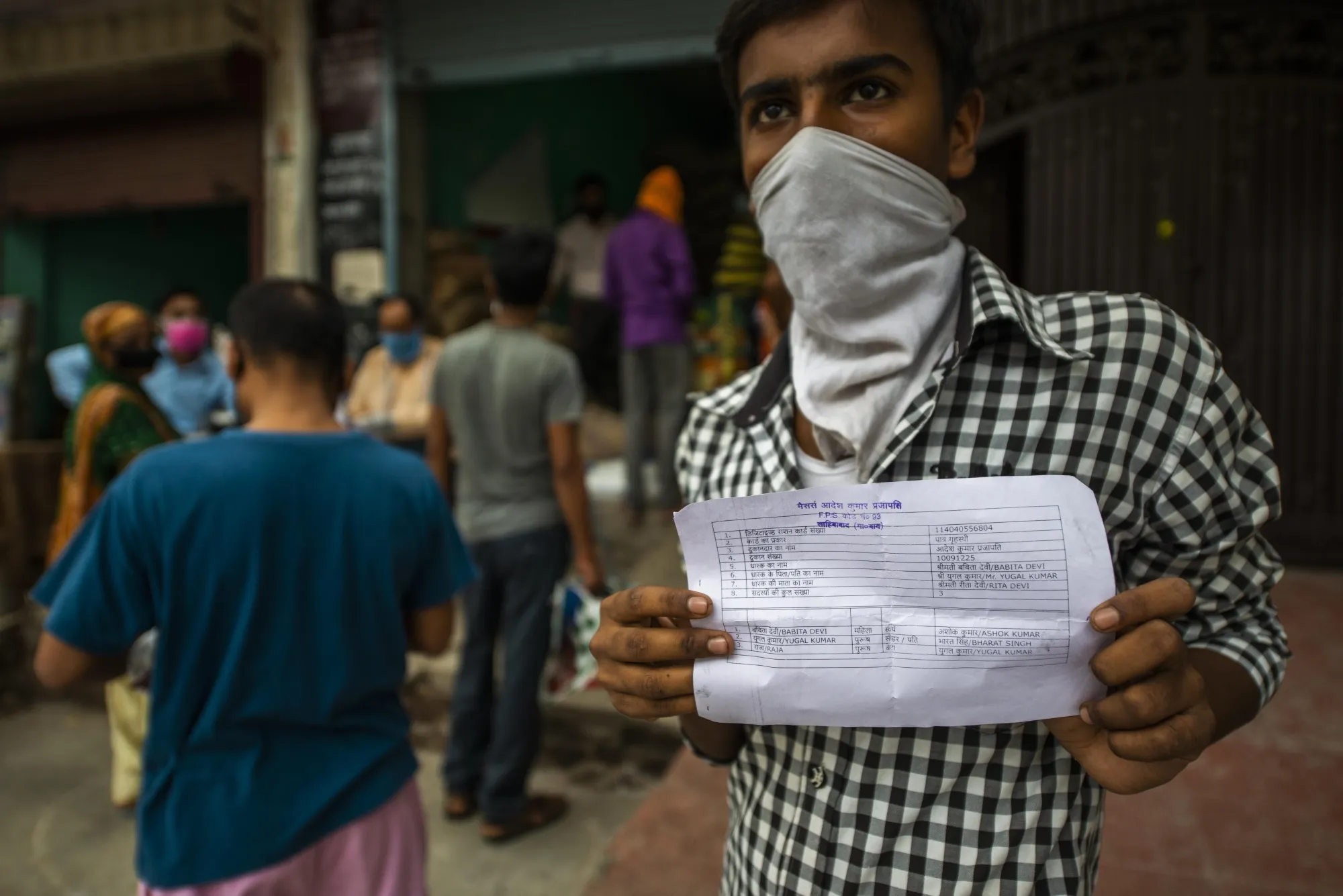 A man shows proof of his temporary ration card.