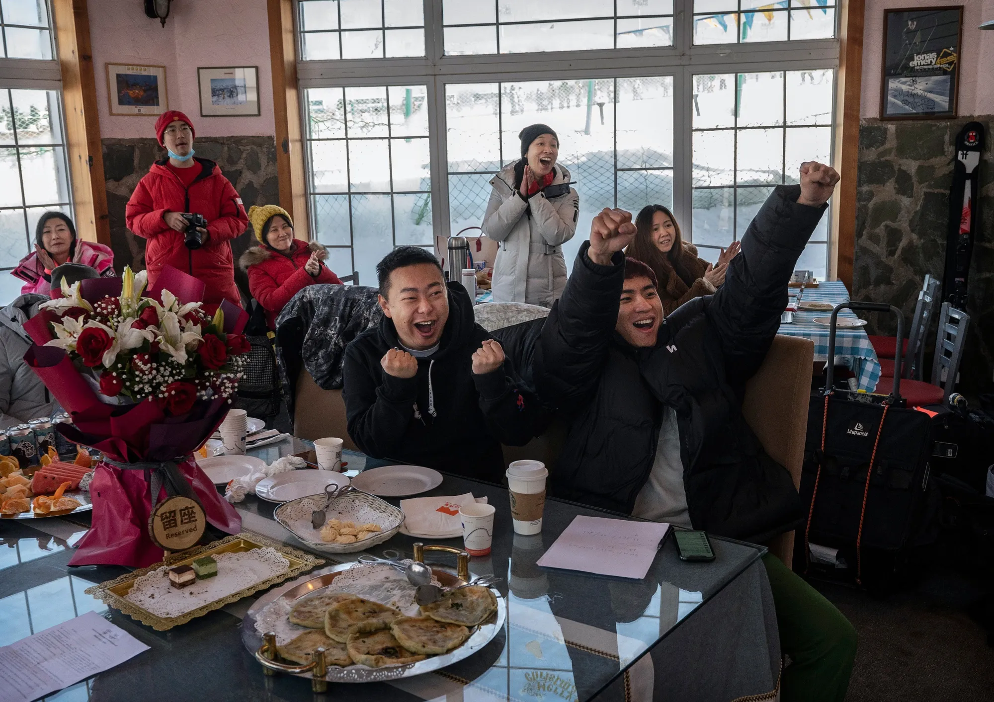 Supporters of freestyle skier Eileen Gu react as they watch her silver medal winning performance&nbsp;at the Beijing 2022 Winter Olympics&nbsp;on television in Beijing, China.&nbsp;