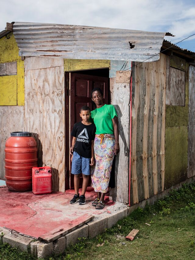 Hurricane Beryl toppled Julett Morgan’s (right) wooden home in Rocky Point, Jamaica. She stands outside the house with her nephew on Sept. 10, 2024.