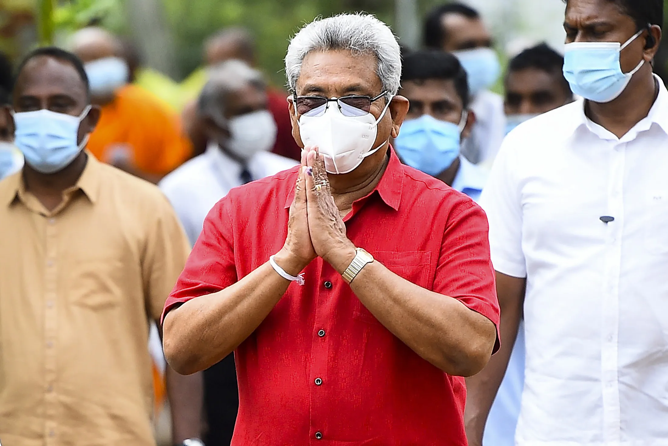 Gotabaya Rajapaksa, center, leaves a polling station after casting his ballot in Colombo on Aug. 5.
