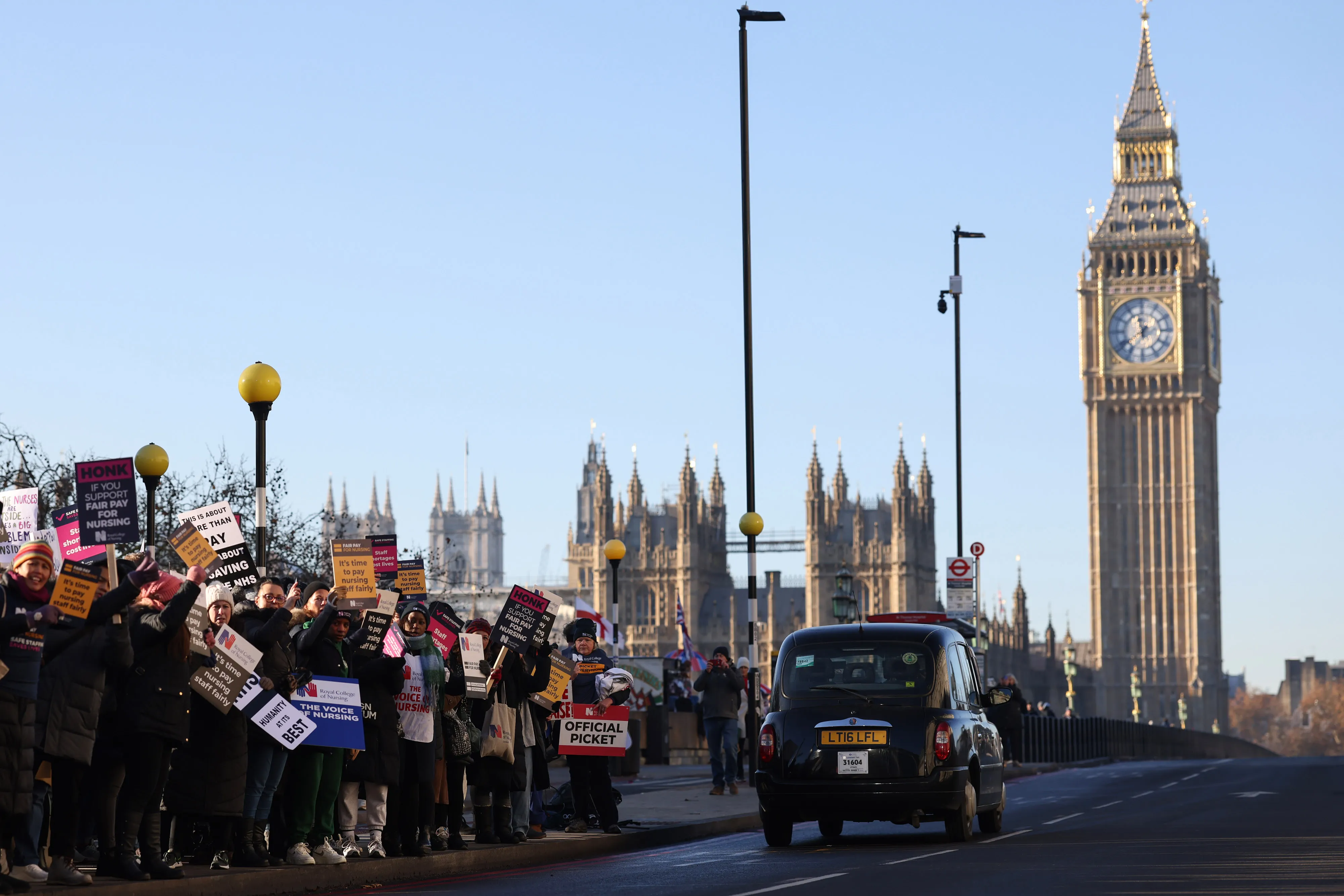 Demonstrators hold placards on a picket line for NHS nursing staff outside St. Thomas' Hospital in London.&nbsp;