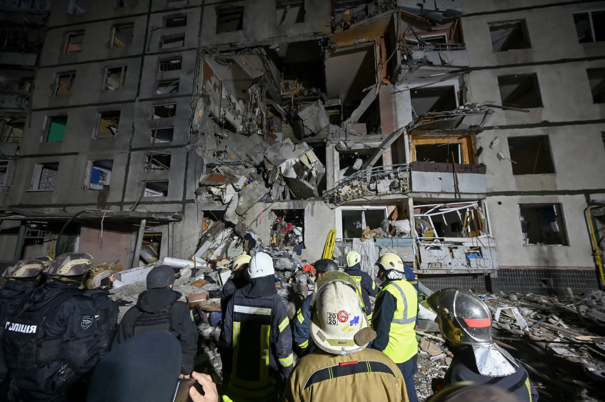 Police officers and State Emergency Service of Ukraine rescuers work near an apartment building damaged after an airstrike in Kharkiv, on Oct. 31.
